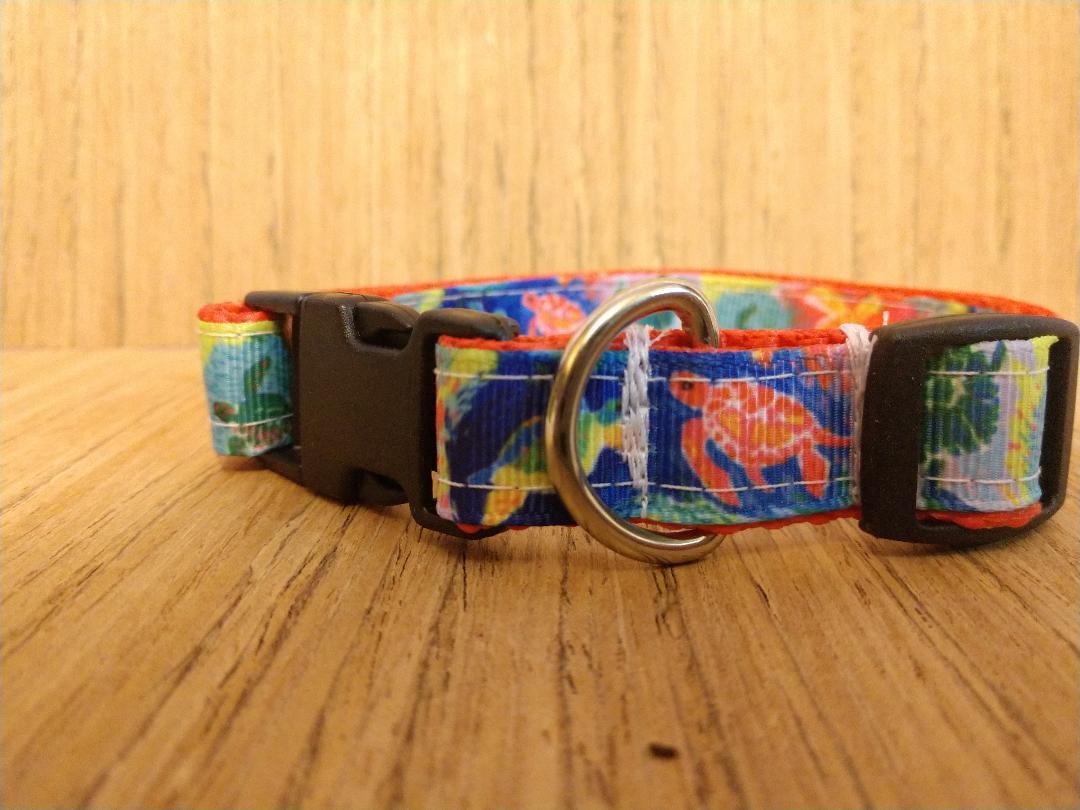 A small dog collar featuring a vibrant sea turtle design, measuring 12-16 inches in neck size, made with durable materials.